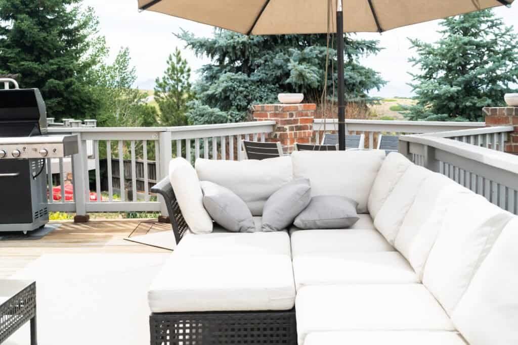 Comfortable outdoor lounge area with sectional sofa and umbrella.