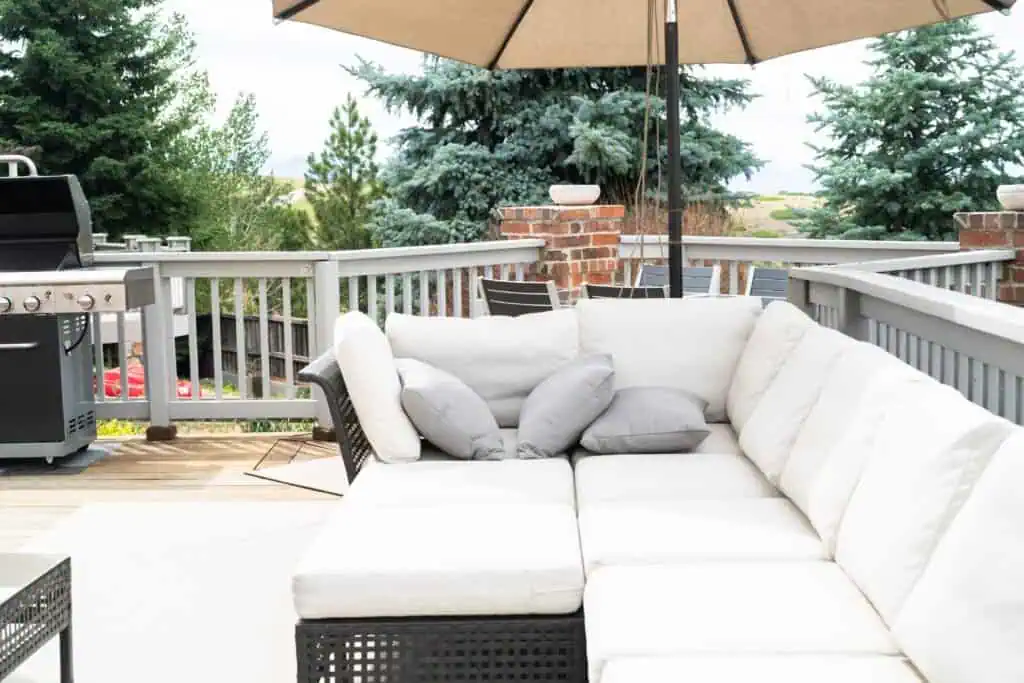 Comfortable outdoor lounge area with sectional sofa and umbrella.